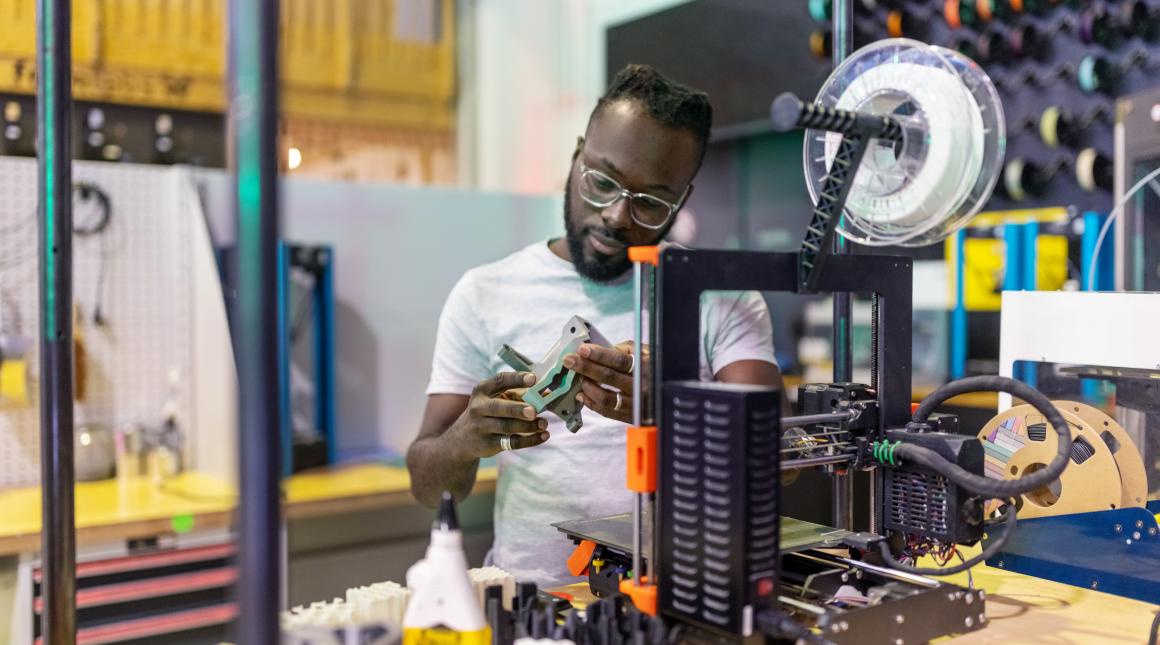 Researcher working with a 3D printer