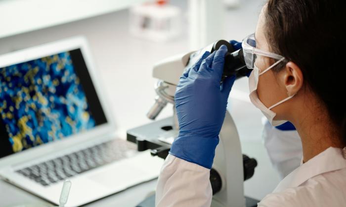 Researcher with microscope