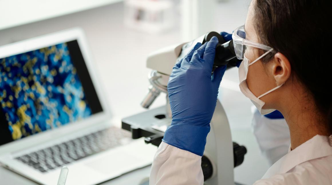 Researcher with microscope