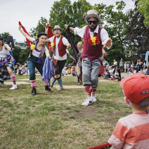 Performers dance outside on the grass at a Turner Sims Southampton family day 